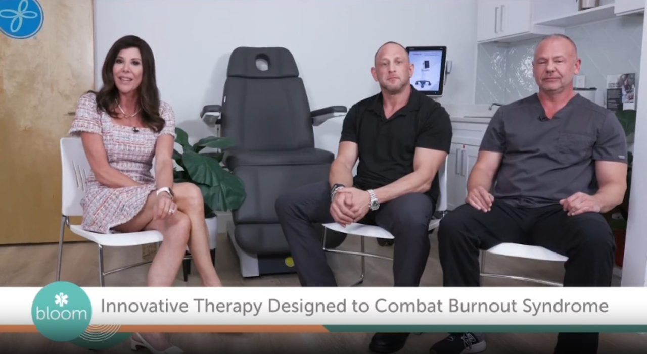 The WFLA host with Reboot Vitality's team in the treatment room
